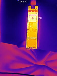 Thermal image of SSD under load showing controller temperature of approximately 77 degrees Celsius