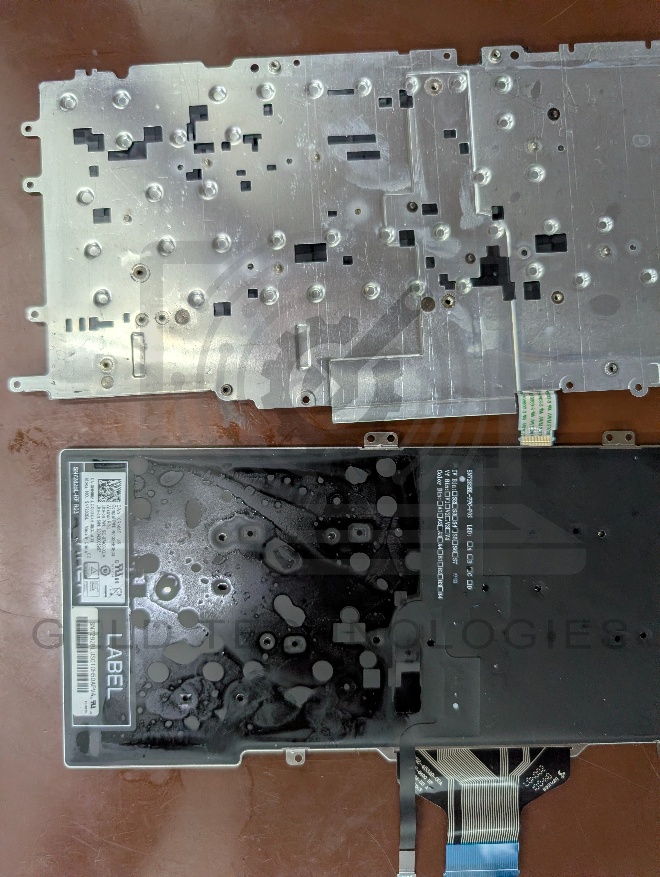 Residual liquid visible on Dell Latitude 7400 fan housing and motherboard underside
