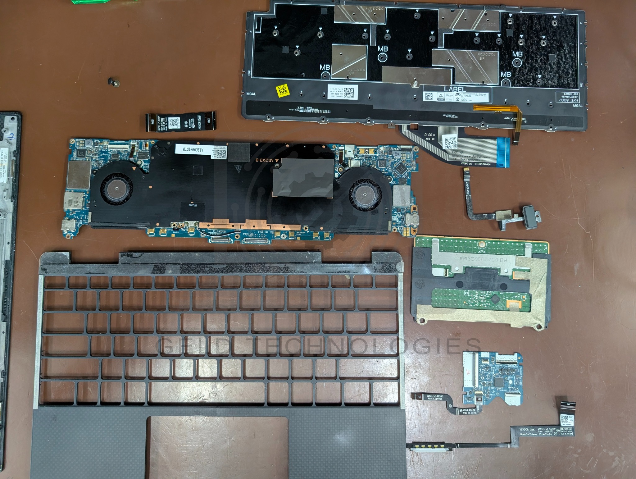 Dell XPS 13 7390 2-in-1 dismantled palmrest and keyboard assembly during component transfer