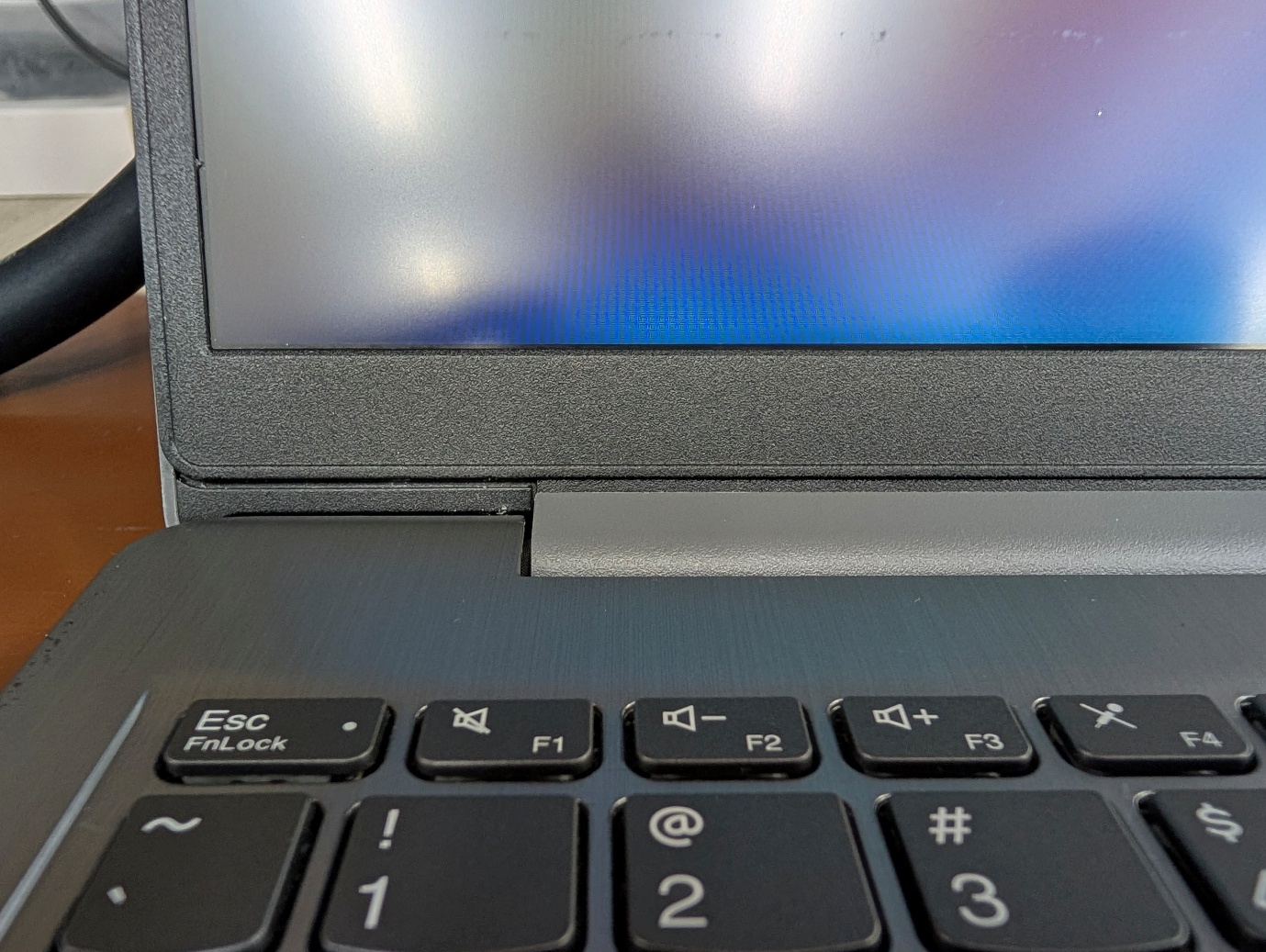 Lenovo IdeaPad 3 reassembled with repaired hinge holding the lid firmly in position
